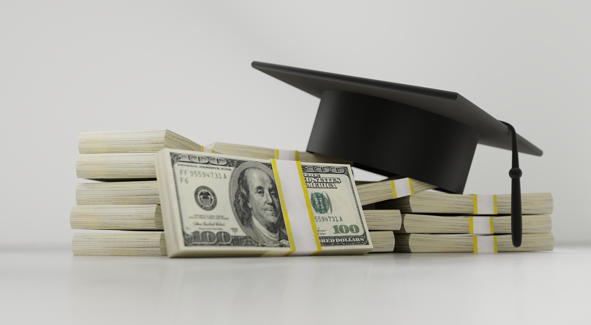 Cash and a graduation cap representing student loans