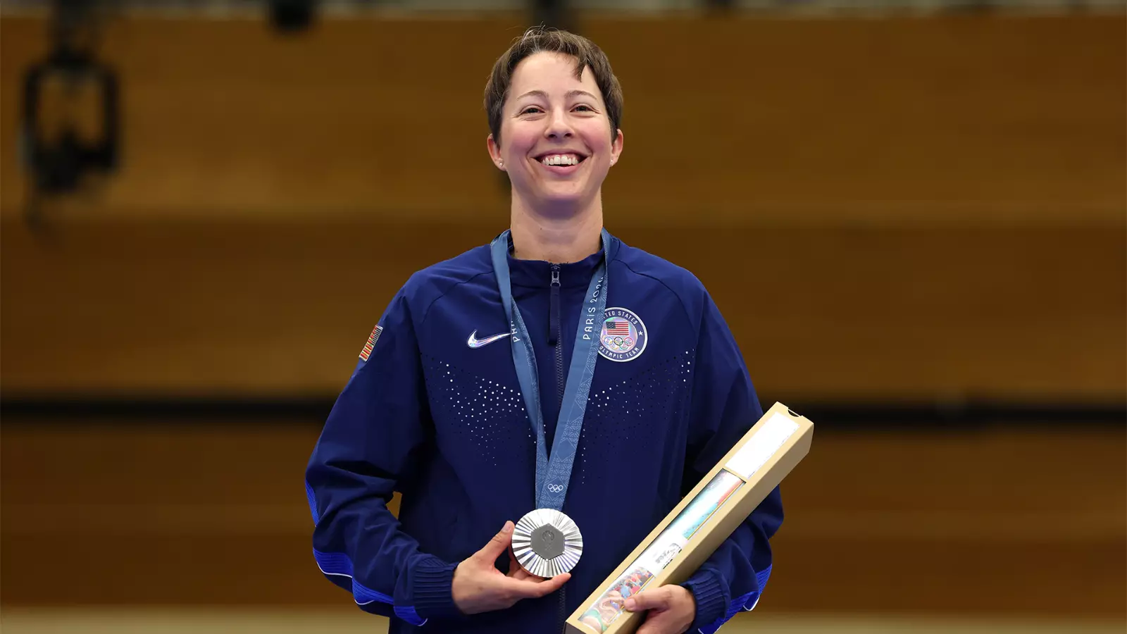 Sagen Maddalena poses with Olympic medal around her neck