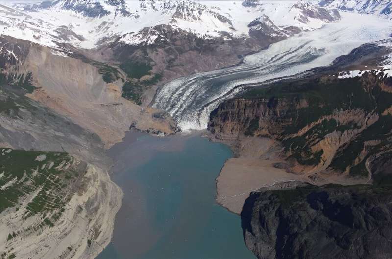 The debris field from an October 2015 landslide extends over the toe of the Tyndall Glacier and in to the Taan Fjord in spring 2016. Credit: Chris Larson