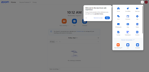 zoom web experience Screenshot of the Zoom web application home screen. A welcome pop-up titled “Welcome to the new Zoom web experience” appears in the upper right, with buttons labeled “Remind me later” and “Next.” Behind the pop-up, the Zoom dashboard shows the current time (10:12 AM), icons for New Meeting, Join, and Schedule, and a message indicating no meetings are scheduled. An expanded menu panel on the right displays additional Zoom options, including Home, Zoom Mail, Calendar, Whiteboard, Notes, Team Chat, and Phone.