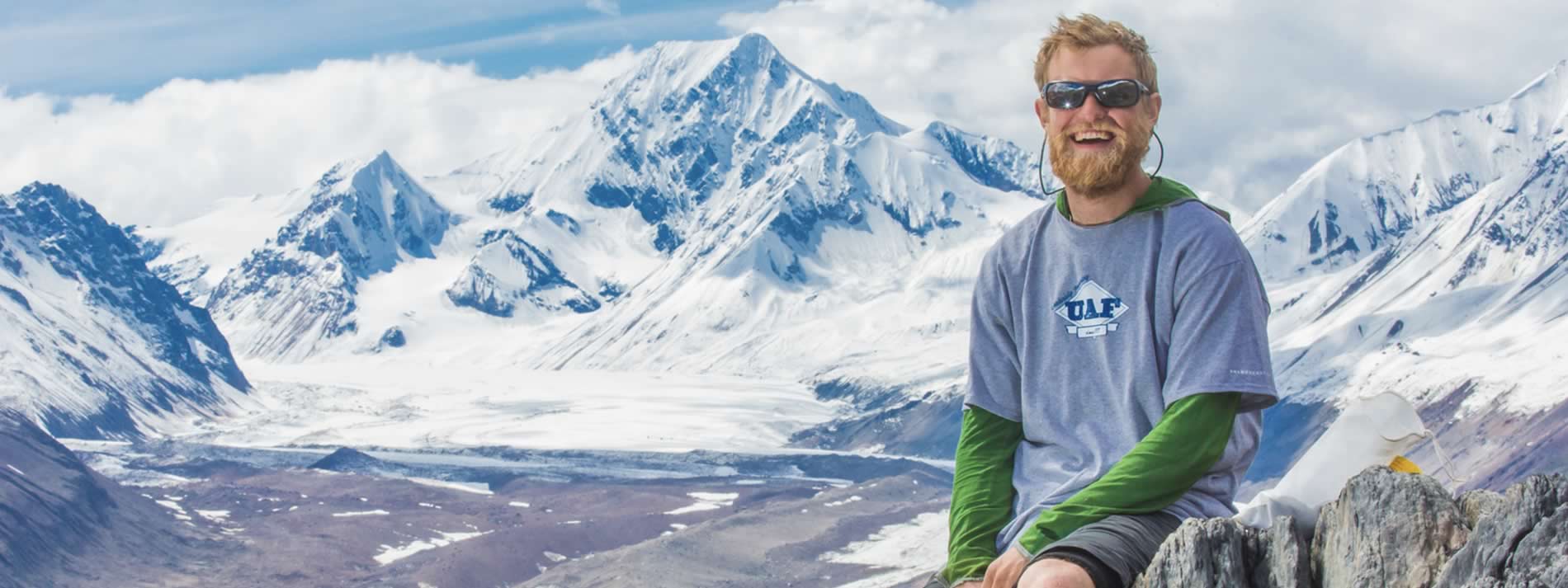 research student with mountains in the background