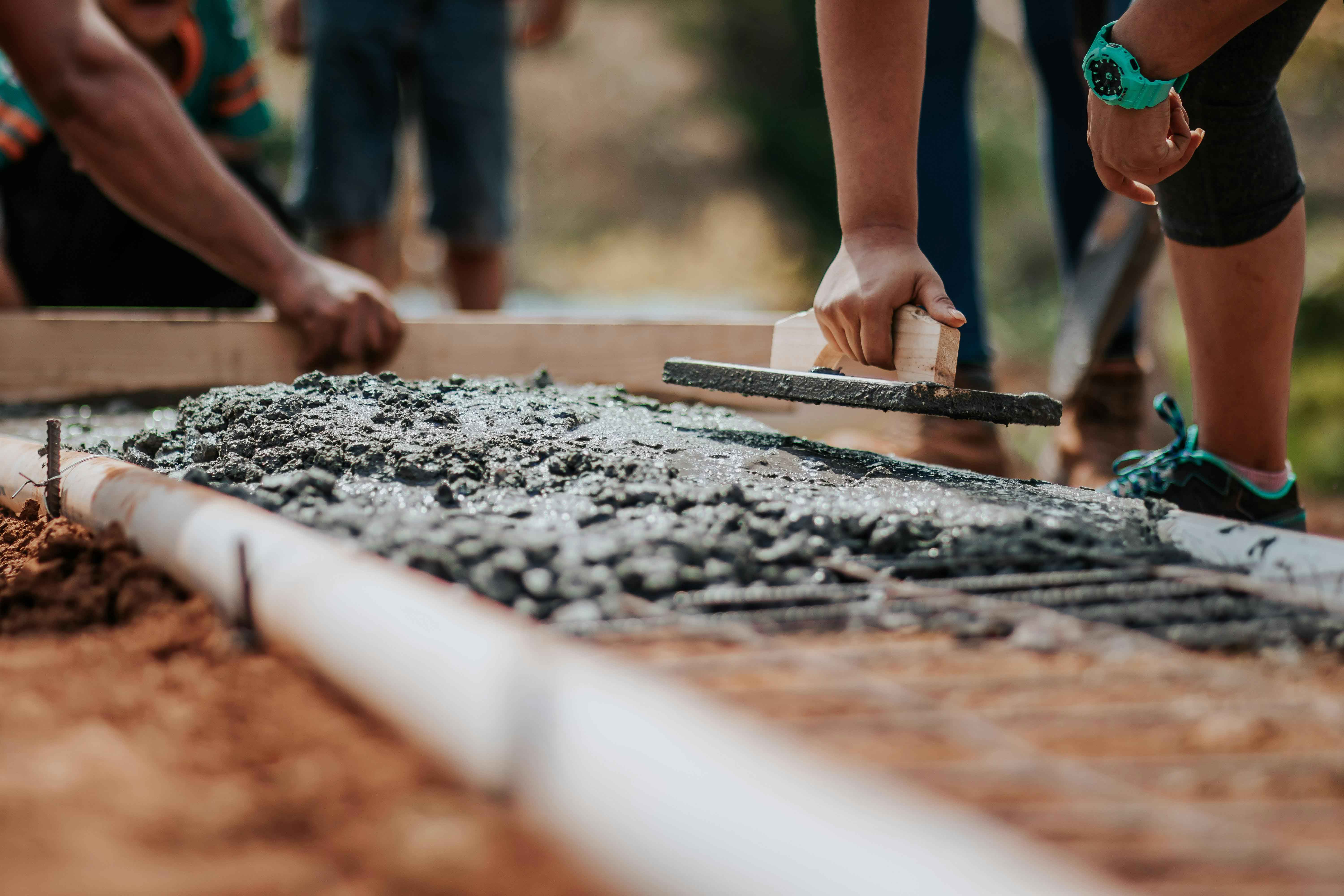 Builders laying a foundation