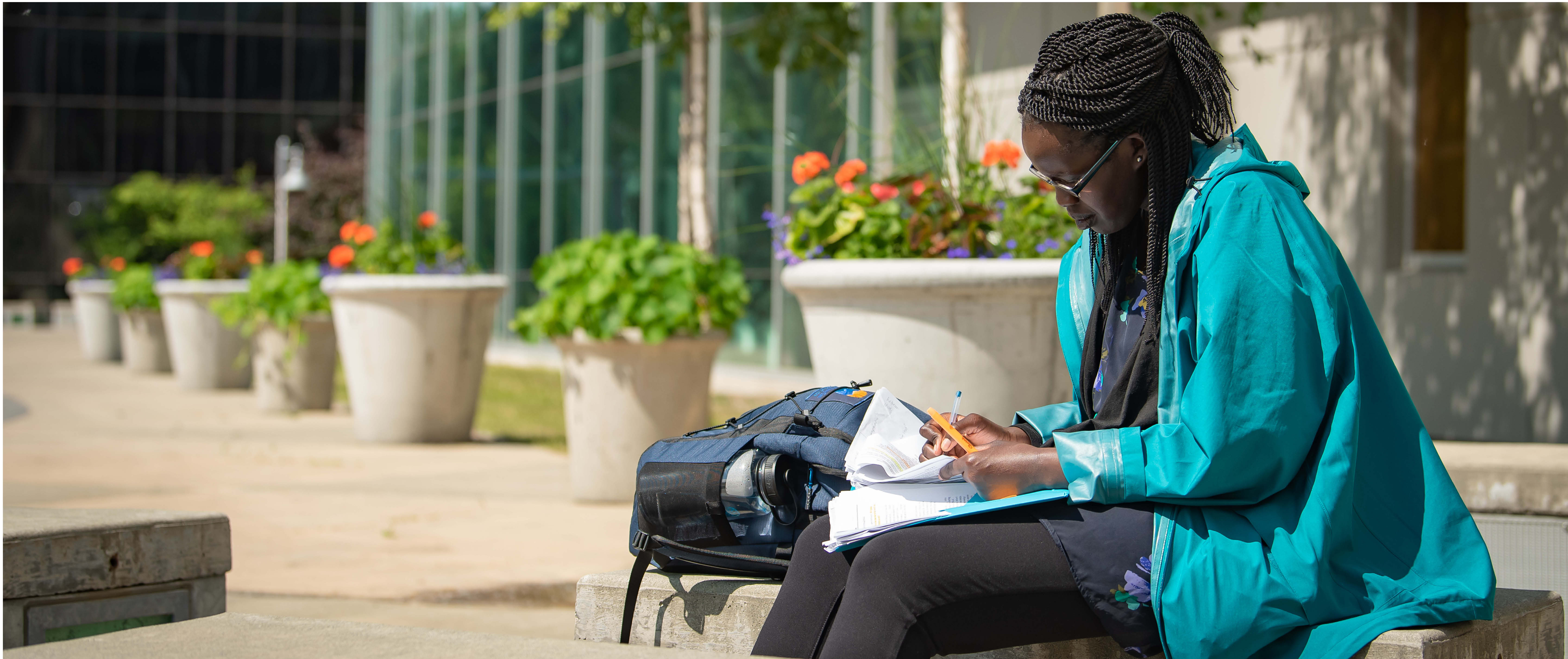 Studying student outside on bench