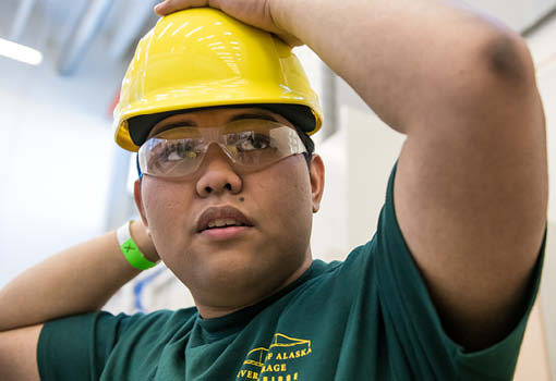 UA student wearing hard hat and safety glasses.