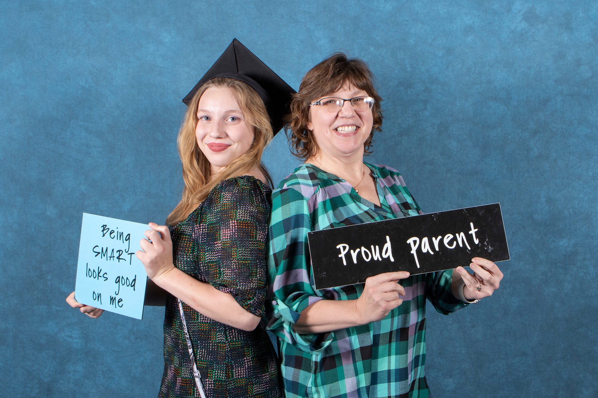 Daughter and daughter standing back to back