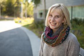 Annika is outside, smiling at the camera