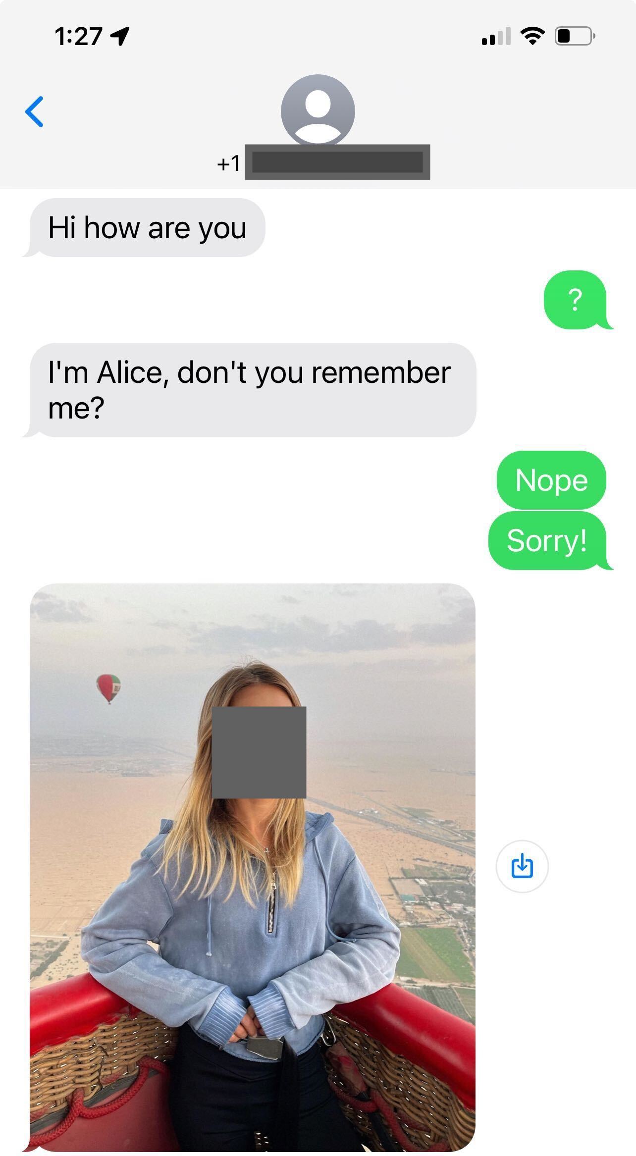 Image of a text message exchange with phone number and face of person redacted