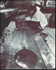 John Iyap in his kugeri on Little Diomede Island. The entry hole is seen in the foreground. Photo: The Northern Engineer