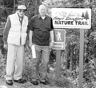 Boyd Shaffer, right, and Clayton Brockel stand at the head of the nature trail that was named for Shafer. Photo: Kenail Peninsula College, Sept. 2002