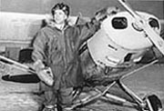 The "Flying President" Dr. Terris Moore, an expert high-altitude pilot, with his Super Cub ski plane. Photo: University Relations Collection, Rasmuson Library