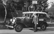Joe in Seattle with a car around 1920s.