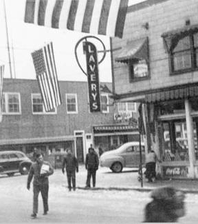 Photograph of Lavery's Grocery Store with flags waving in preparation for the Winter Carnival around 1946-1948. Photo: University of Alaska Rasmuson Library, Cecil H. Kornegay Photograph Collection