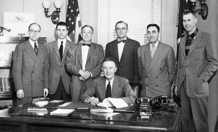 March 21, 1955. Governor B. Heintzleman signing bill authorizing a statehood convention to be held November 8, 1955 at the University of Alaska. Right to left: Repr. Tom Stewart, Juneau; Senator John Butrovich, Fairbanks; Senator Earl Cooper, Anchorage; House Speaker, Wendell Kay, Anchorage; Senate President, James Nolan, Wrangell; House Minority leader, Joseph McLean, Juneau. Photo by Joseph W. Alexander